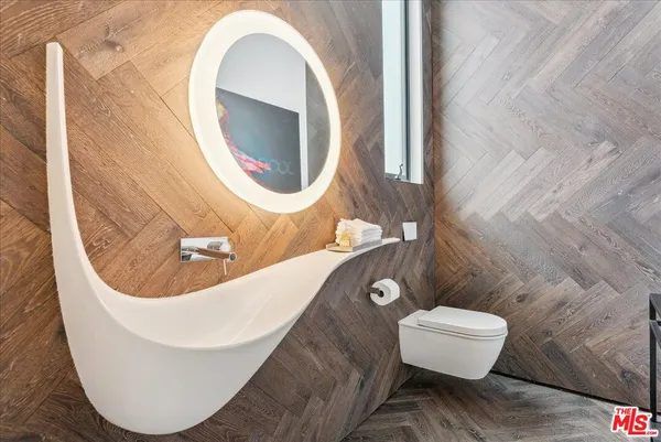 a bathroom with a toilet and a mirror