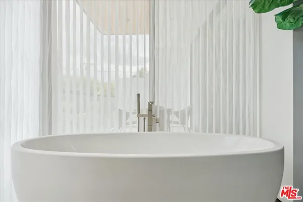 a bathroom with a bathtub and shower