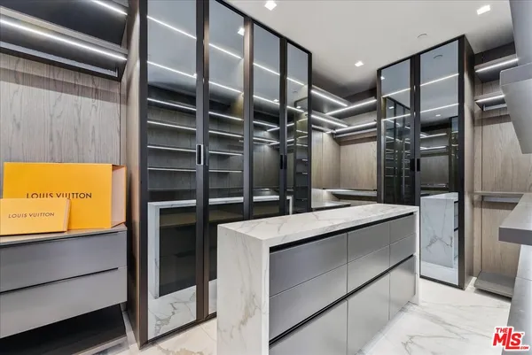 a kitchen with stainless steel appliances kitchen island granite countertop a refrigerator and a stove