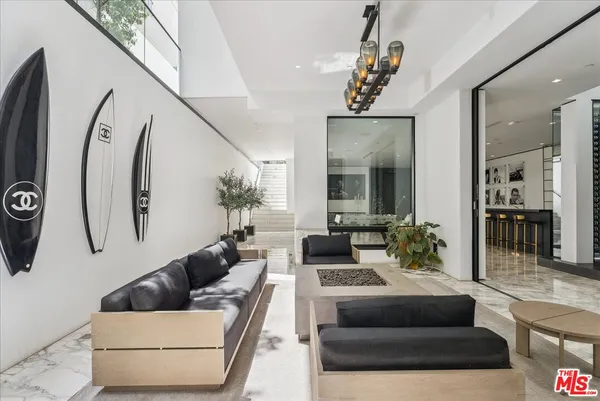 a living room with furniture and a chandelier