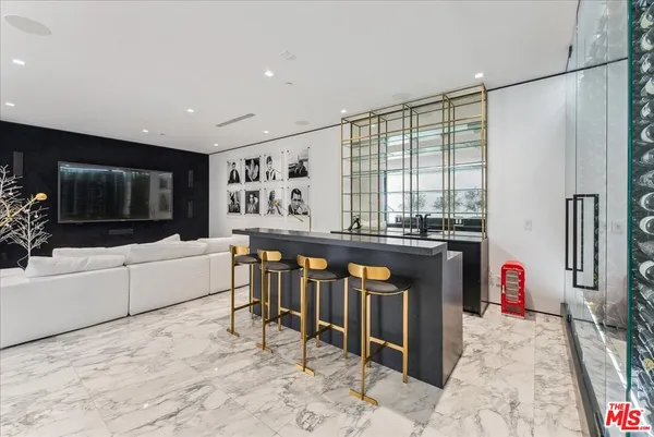a living room filled with furniture and a flat screen tv