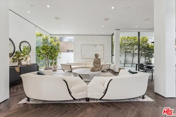 a living room with couches and chandelier