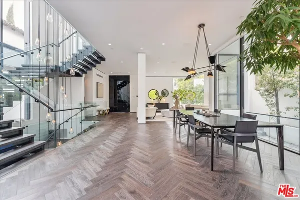 a view of a dining room with furniture window and wooden floor