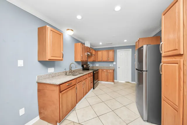 a kitchen with stainless steel appliances granite countertop a refrigerator sink and cabinets