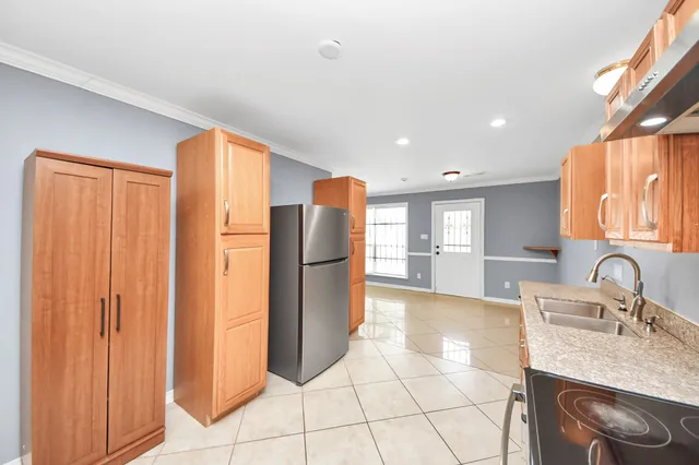 a kitchen with refrigerator and cabinets