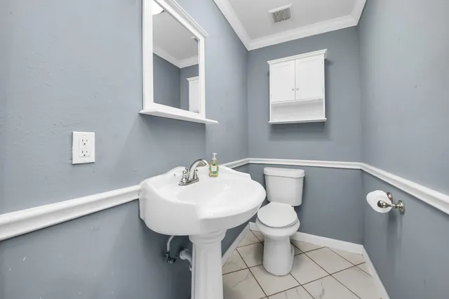 a bathroom with a sink a toilet and mirror