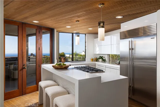 a kitchen with a refrigerator a stove and a kitchen island