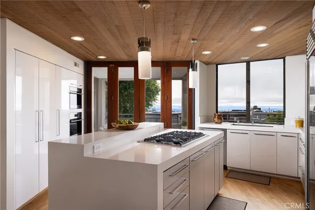a kitchen that has a sink a stove and a refrigerator