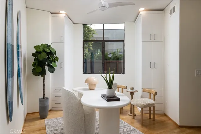 a living room with furniture and a potted plant