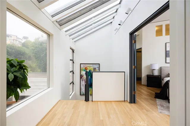 a view of a bedroom with furniture and a hallway
