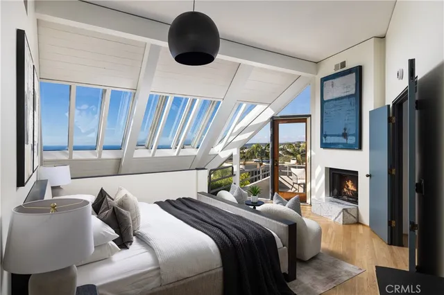 a bedroom with a bed and a large window