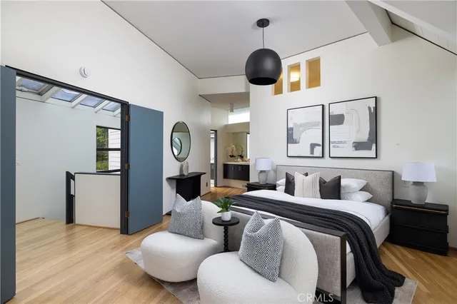 a bedroom with furniture and a large window