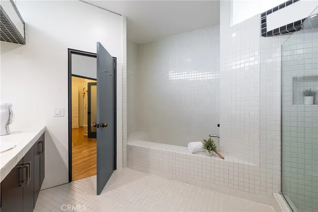 a bathroom with a bathtub and a shower
