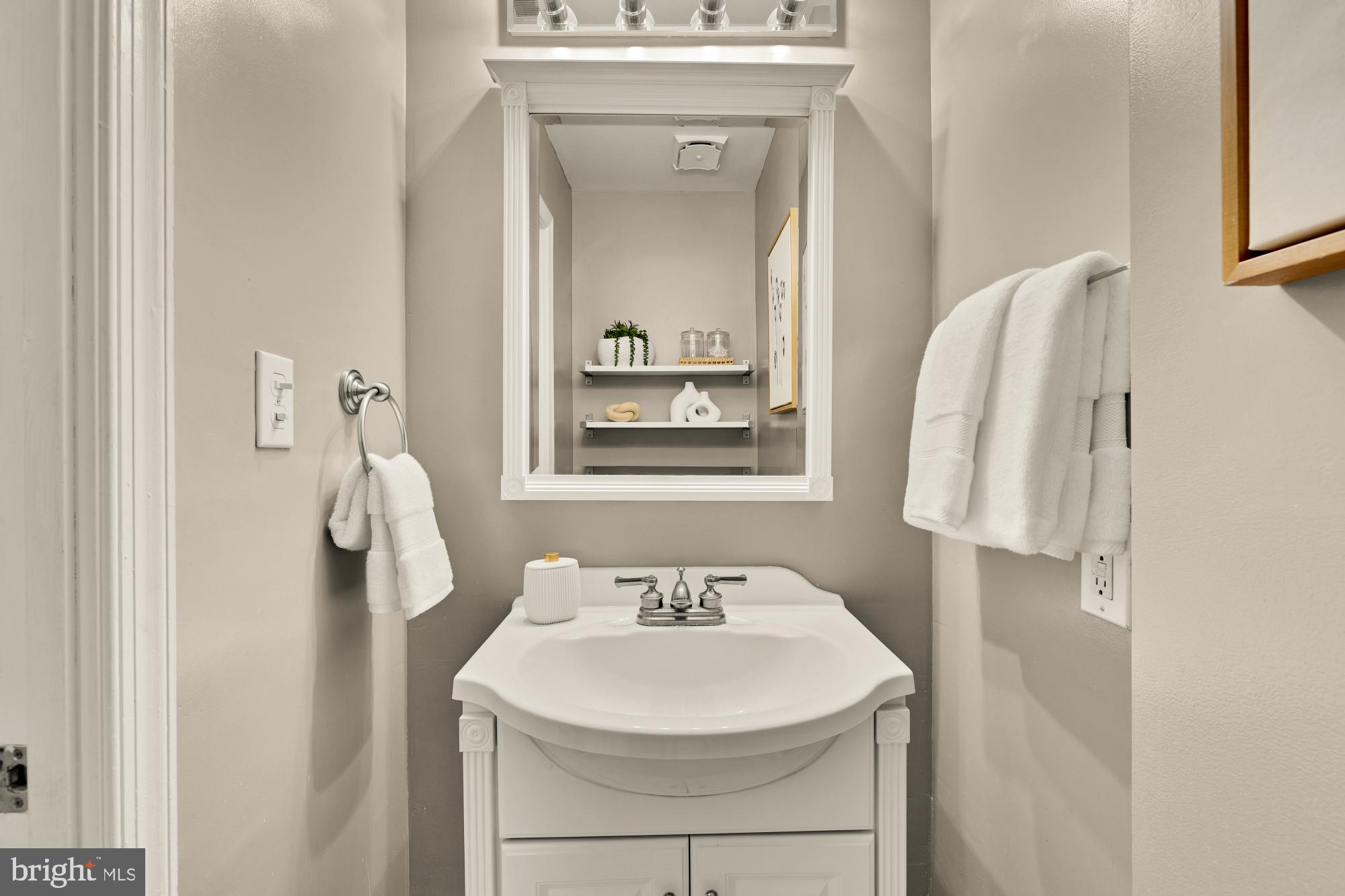 1715 15th Street Northwest, Unit 101 Washington, DC 20009 - Photo 11 of 24 a bathroom with a sink and mirror with window