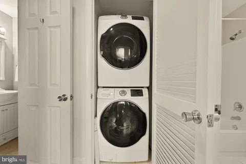a bathroom with a sink and mirror with window