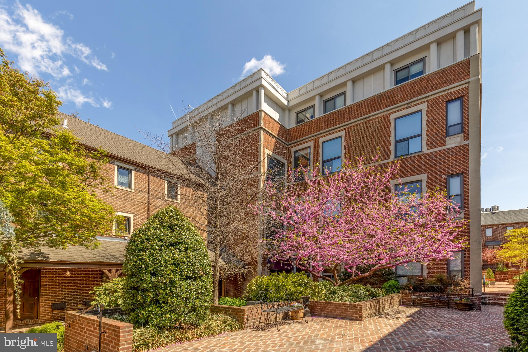 1715 15th Street Northwest, Unit 101 Washington, DC 20009 - Photo 15 of 24 a front view of a multi story residential apartment building with a yard