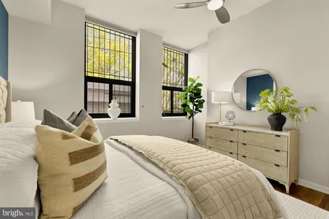 a bedroom with a bed and wooden floor