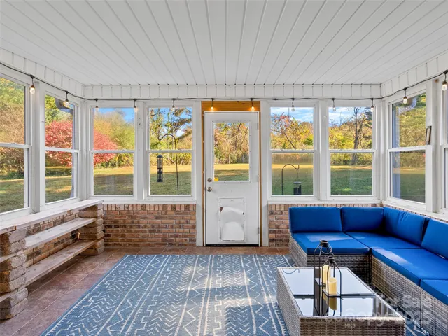 a living room with furniture and large windows