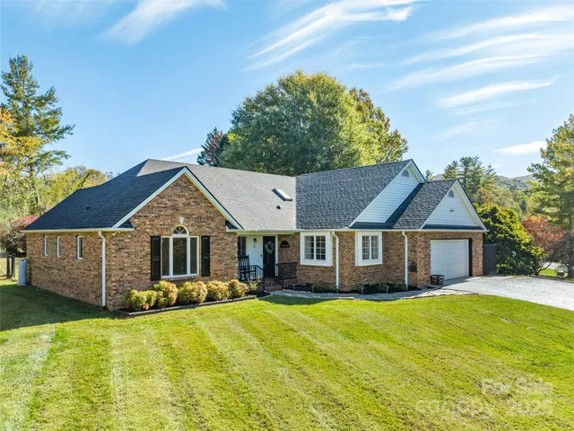 a front view of a house with a yard table and chairs