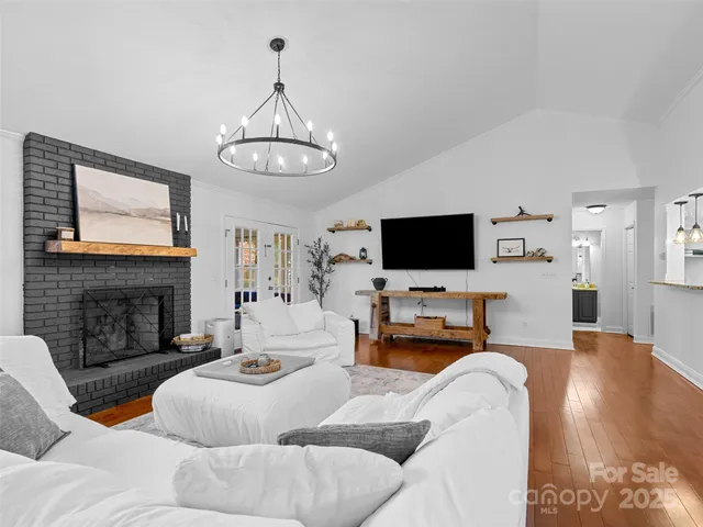 a living room with furniture flat screen tv and a fireplace