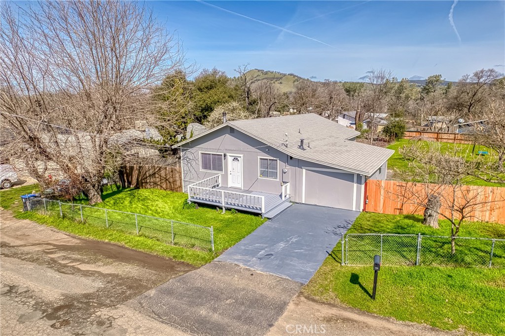 15083 Austin Road Clearlake, CA 95422 - Photo 1 of 1 a front view of a house with a yard and garage