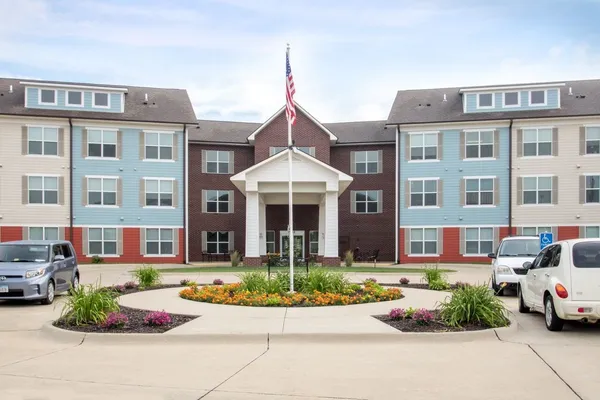 a front view of a residential apartment building with a yard
