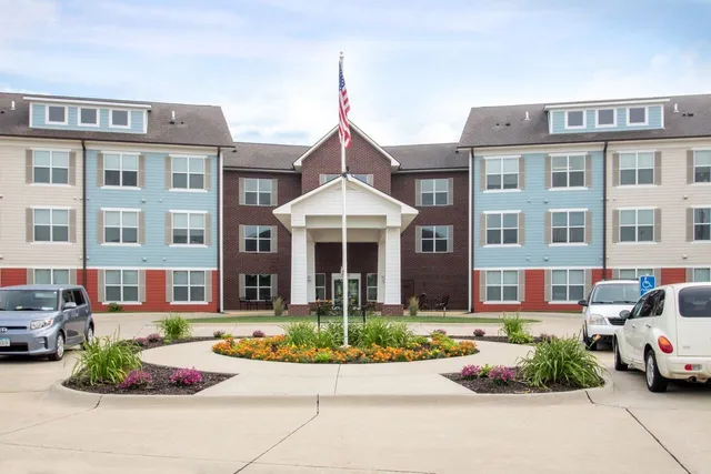 a front view of a residential apartment building with a yard