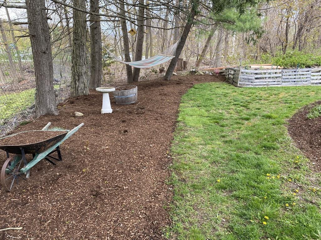 15 Bainridge Road Worcester, MA 01602 - Photo 31 of 40 a view of a backyard with plants and a slide