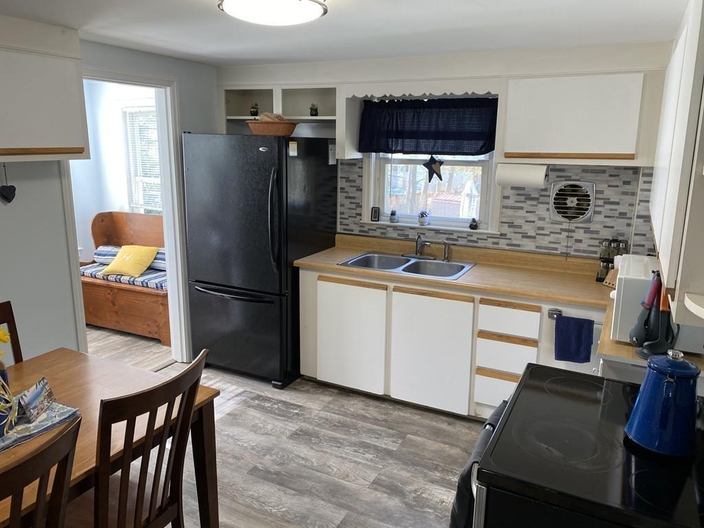 15 Bainridge Road Worcester, MA 01602 - Photo 6 of 40 a kitchen with stainless steel appliances a stove a refrigerator a sink a dining table and chairs