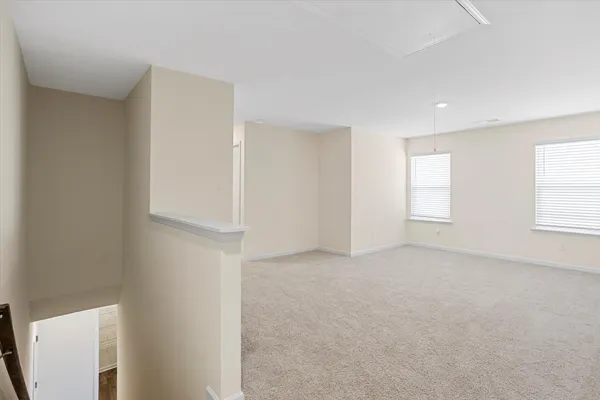 a small space with a window and a fan