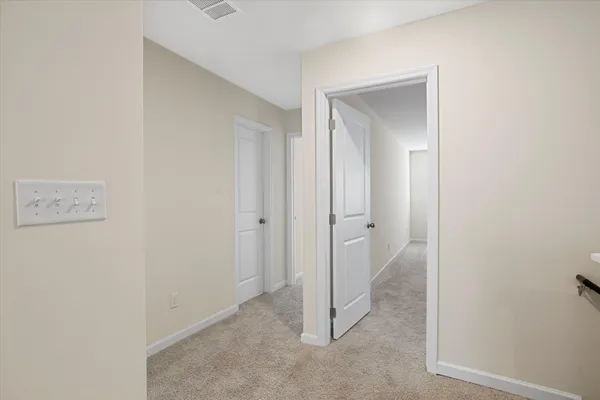 a view of a living room hardwood floor and a kitchen