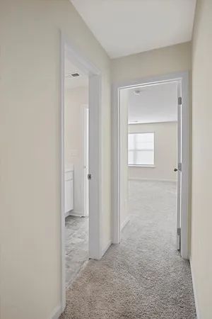 a room with white cabinets and wooden floor