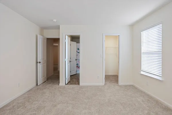a kitchen with granite countertop a refrigerator and a stove top oven