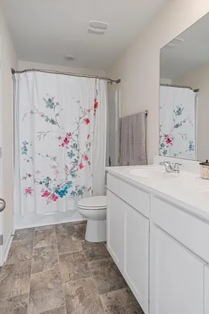 a kitchen with a dining table chairs refrigerator and cabinets