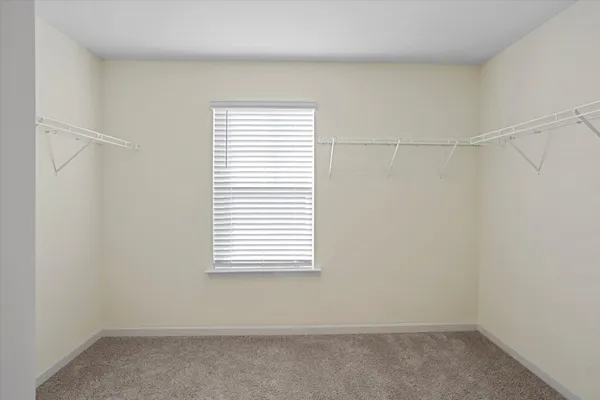 a small space with a window and a fan