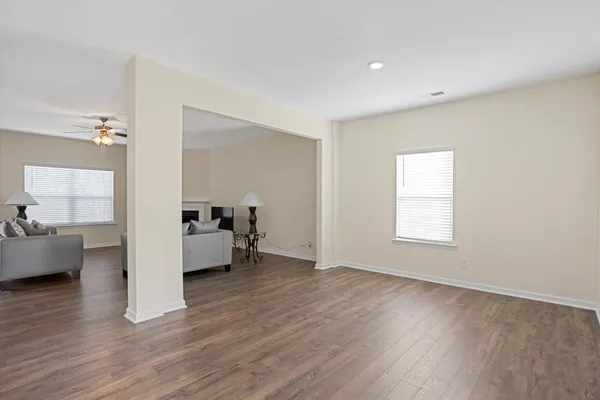 a view of a living room hardwood floor and a kitchen