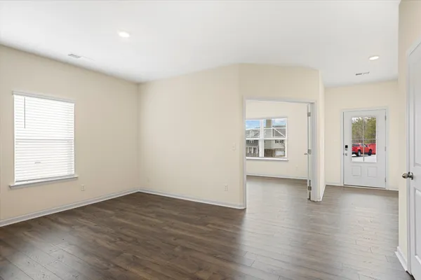 a view of an empty room with wooden floor