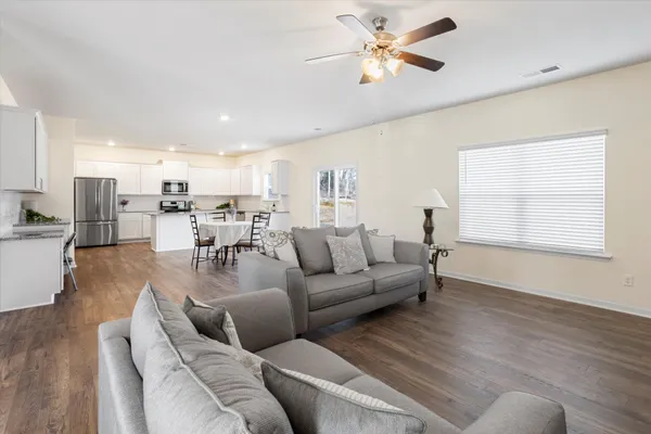 a living room with furniture a fireplace and a flat screen tv