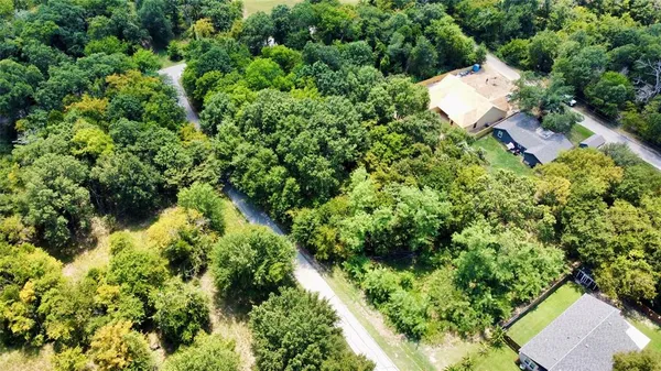 an aerial view of a house with a yard and swimming pool