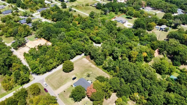 an aerial view of a house with a yard and covered with swimming pool