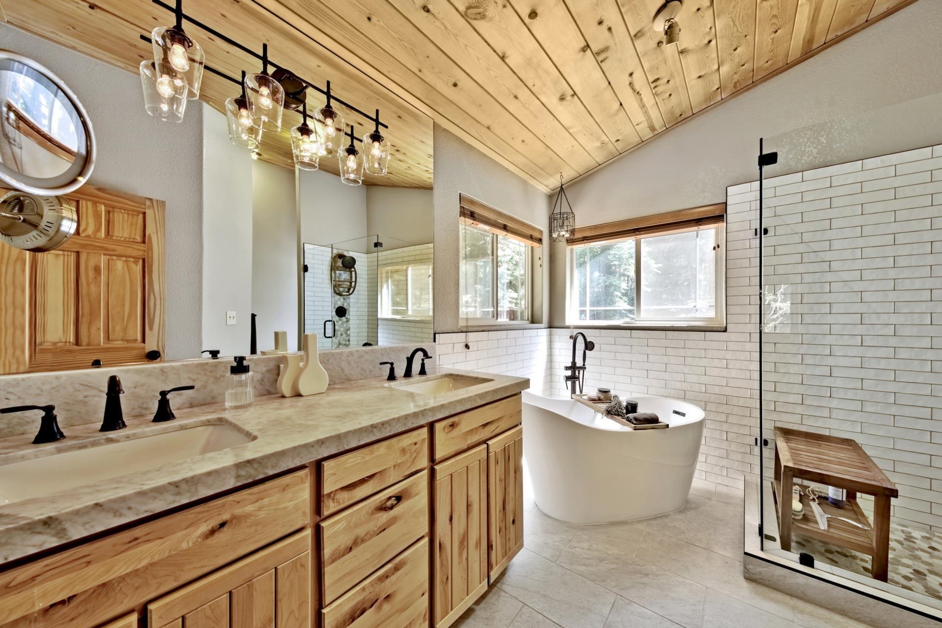10501 Heather Road Truckee, CA 96161 - Photo 12 of 21 a bathroom with a double vanity sink a mirror a bathtub and a shower