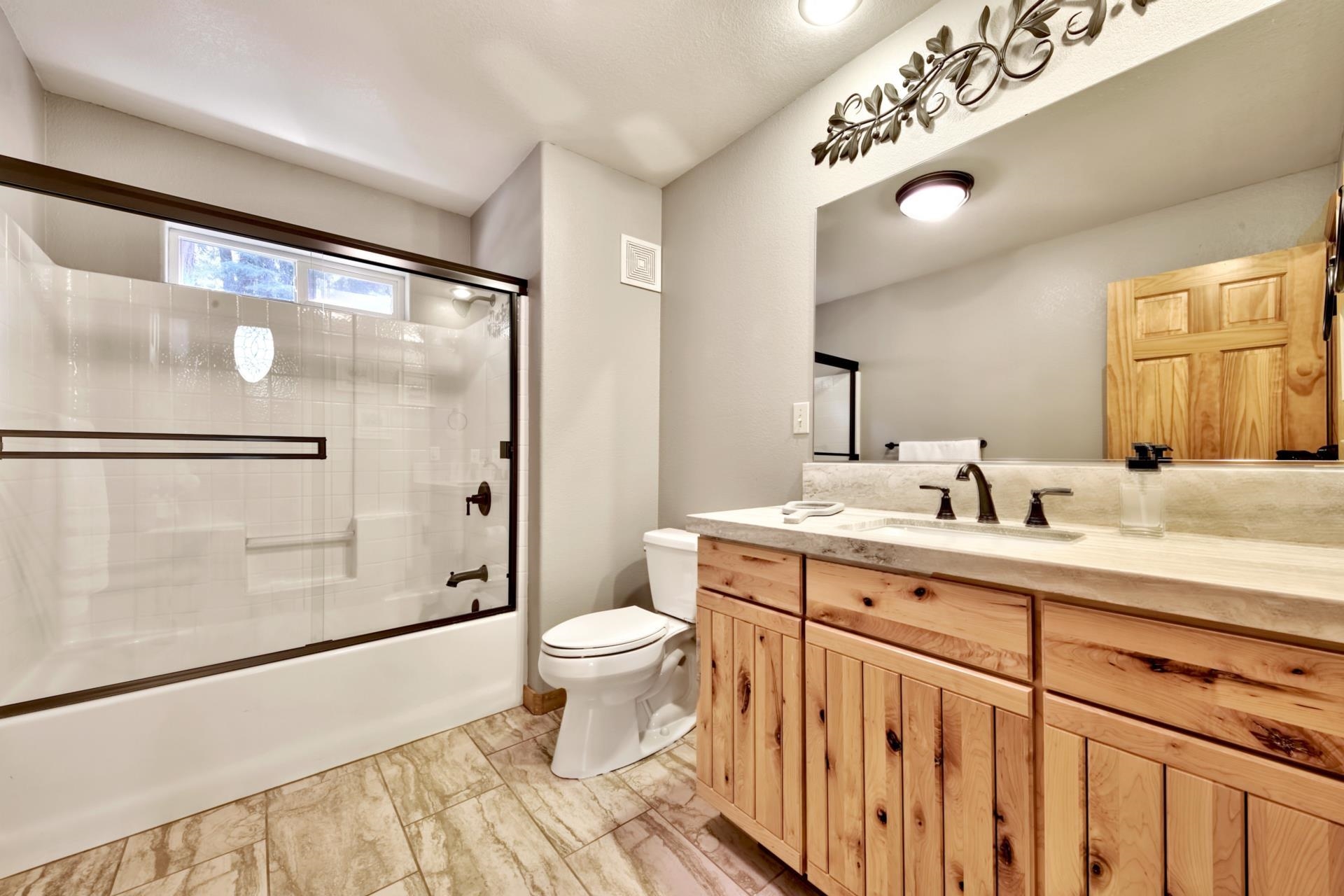 10501 Heather Road Truckee, CA 96161 - Photo 15 of 21 a bathroom with a sink toilet a mirror and shower
