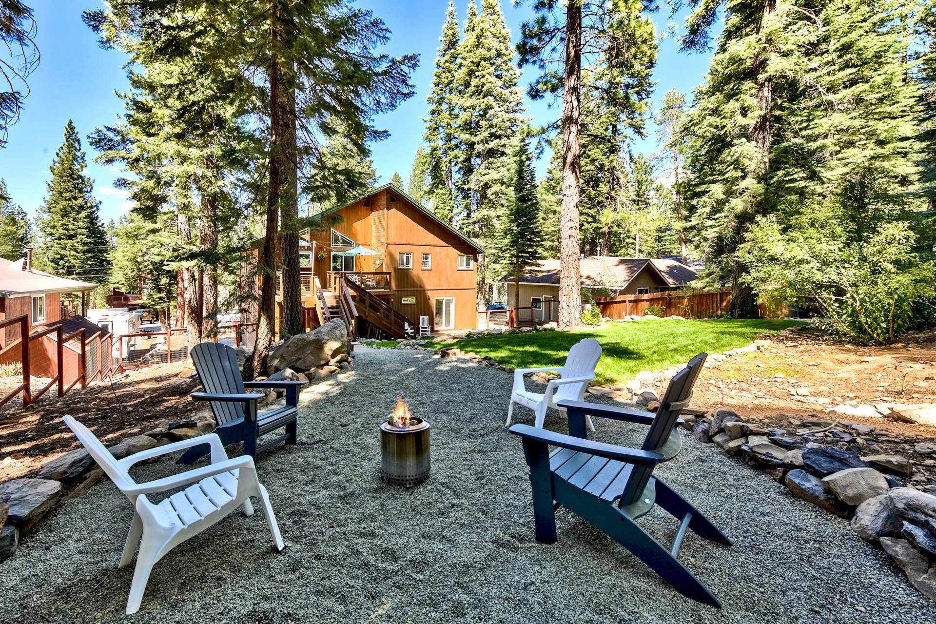 10501 Heather Road Truckee, CA 96161 - Photo 20 of 21 a view of a wooden chairs and fire pit in the backyard