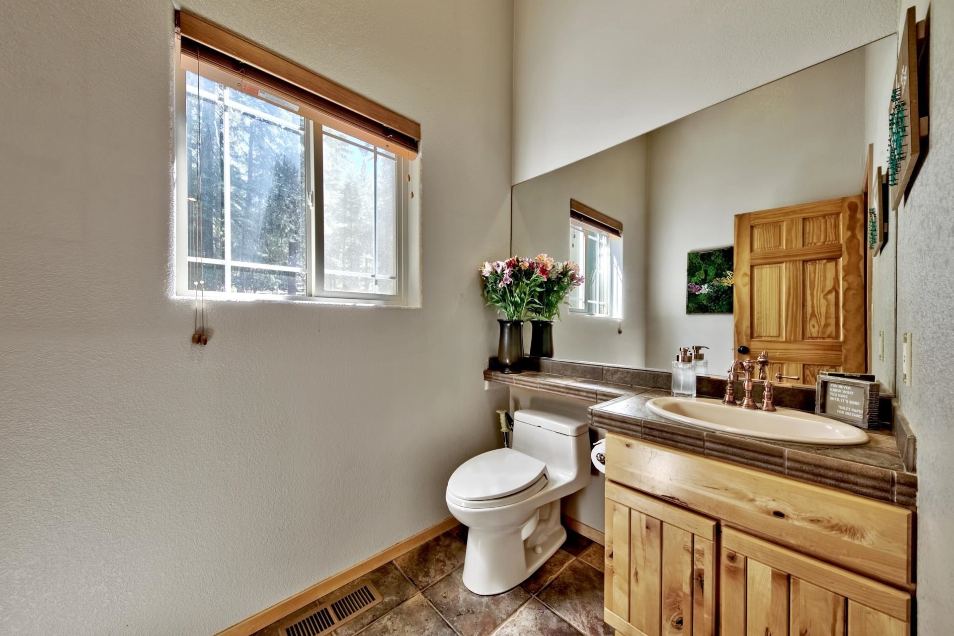 10501 Heather Road Truckee, CA 96161 - Photo 10 of 21 a bathroom with a toilet sink and mirror