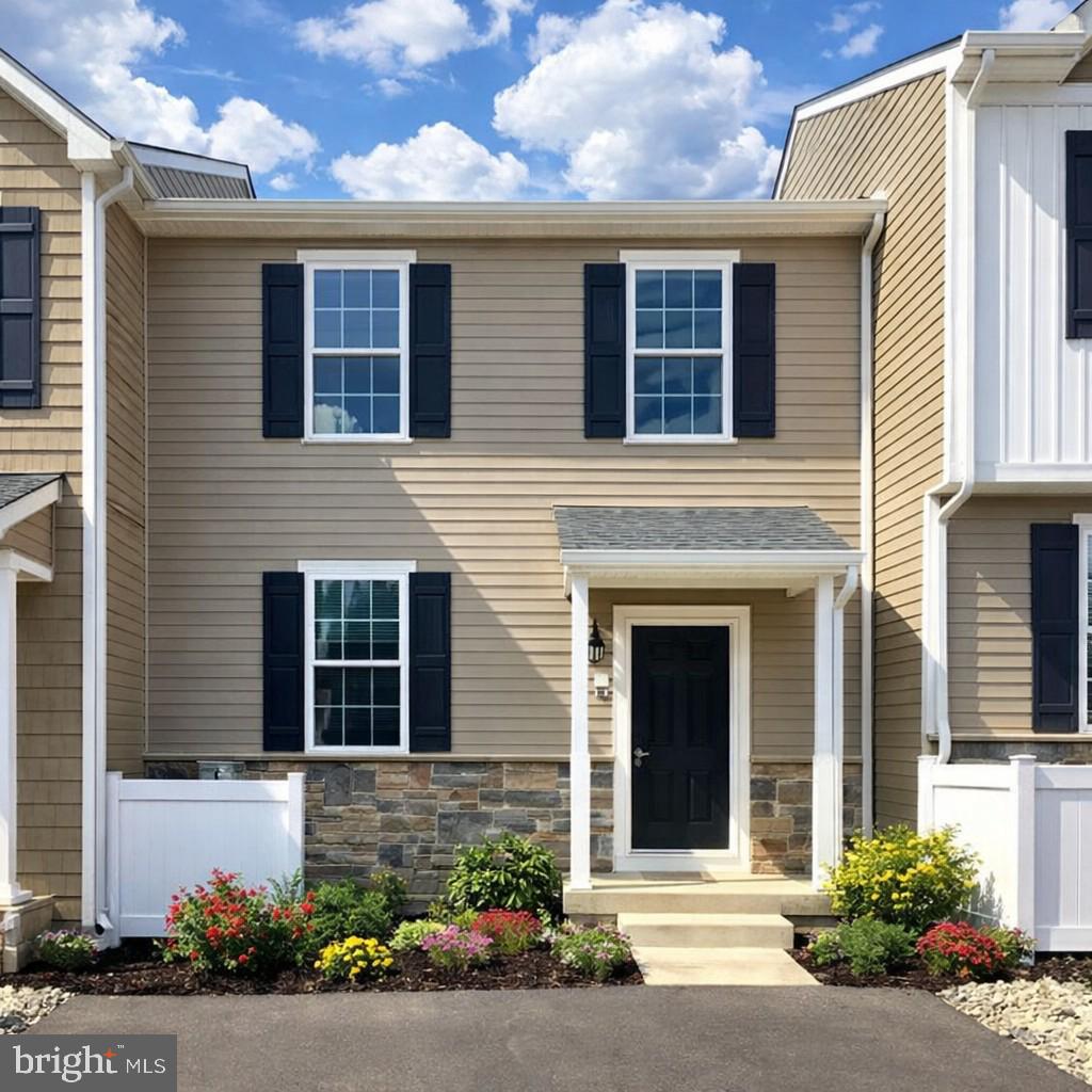a front view of a house with a garden
