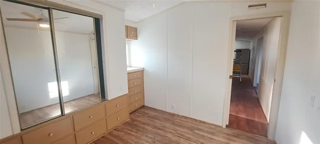 a view of hallway with stairs and wooden floor