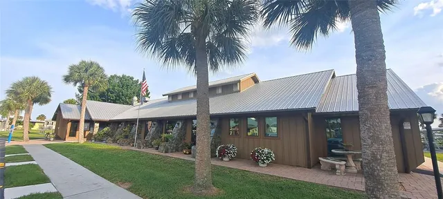 a front view of a house with a garden and patio