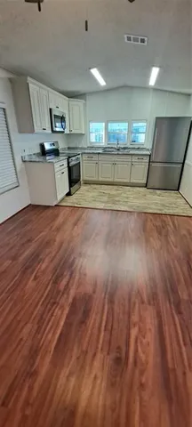 a view of a kitchen with a sink and a microwave