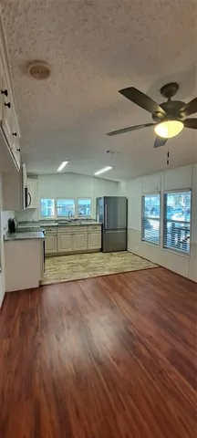 a view of a kitchen with a sink cabinets and a floor to ceiling window