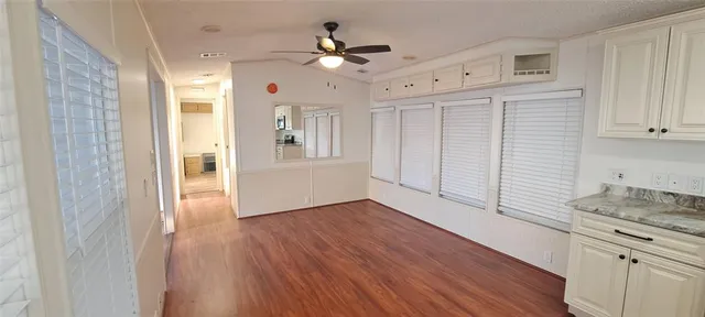 a view of an empty room with a kitchen